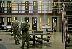 file photo of guantanamo guards keep watch over a cell block with ...