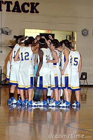 Huddle of high school girls basketball team.