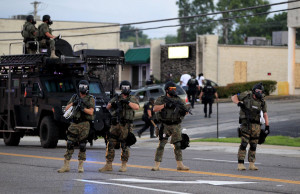 ... gear try to disperse a crowd Monday, Aug. 11, 2014, in Ferguson, Mo