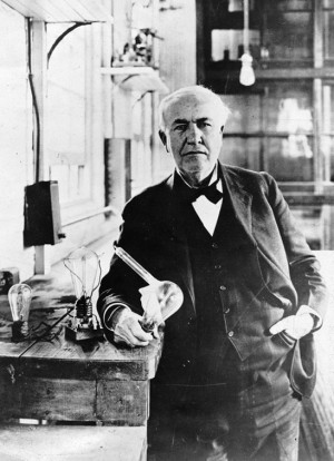 Thomas Edison, with a light bulb
