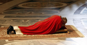 ... floor in prayer during Good Friday service in Saint Peter's Basilica