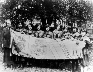 Juliette Gordon Low stands with a group of Girl Scouts in 1924, three ...