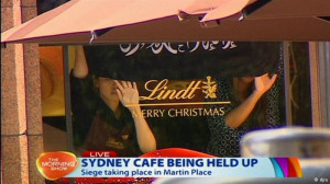 Two hostages were made to hold a flag up the cafe window