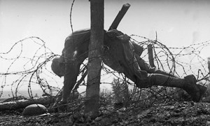 An American soldier lies dead, tangled in barbed wire on the western ...