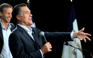Republican presidential candidate Mitt Romney, accompanied speaks to a ...