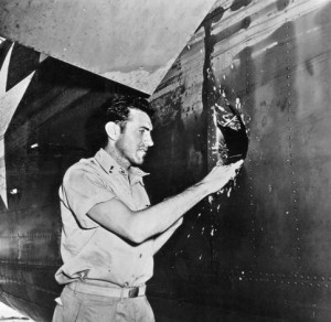 Louis Zamperini examines a hole in Super Man, the B-24 on which he was ...