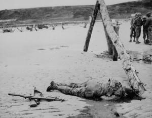 Crossed rifles in the sand placed as a tribute to this fallen soldier.