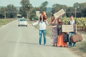 Hippie Group Hitchhiking on a Countryside Road - Stock Image
