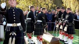 Soldiers of the Scottish 1st Battalion Highlanders lower the coffin of ...