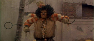 Dorothy finds Scarecrow in a big junk yard being harassed by a flock ...