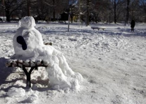snowman sits on a park bench in the Public Garden in Boston ...