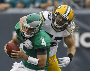 Eagles quarterback Kevin Kolb, left, is sacked by Green Bay Packers ...