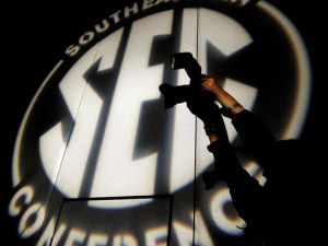 photographer takes a photo at the Southeastern Conference NCAA ...