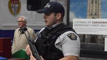 The former head of CSIS, Richard Fadden, walks past an RCMP officer as ...
