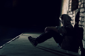 lonely_boy_sitting_on_street