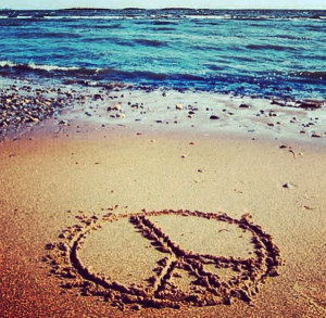 Peace sign in the sand on the beach.