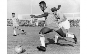 Brazilian forward Pele dribbles past a Swedish defender in 1960. He ...