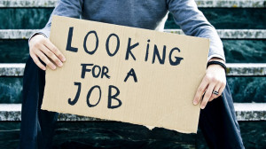 Young businessman holding sign Looking for a job