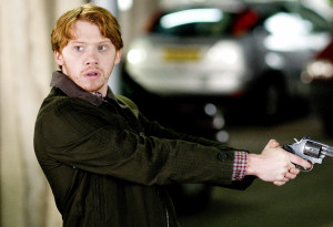 Rupert Grint (Tony) turns to look whilst pointing a gun in the other ...