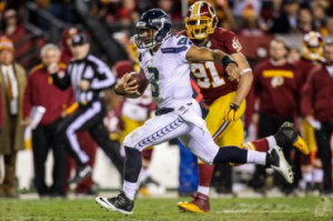 Russell Wilson is pursued by Ryan Kerrigan in the second half. (USA ...