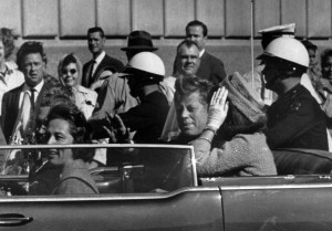President John F. Kennedy is seen riding in motorcade approximately ...