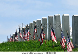 Gravestones decorated with U.S. flags to commemorate Memorial Day at ...