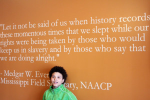 ... (7th grade) standing in front of a powerful Medgar Evers quote