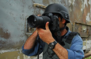 war correspondent takes a photograph.