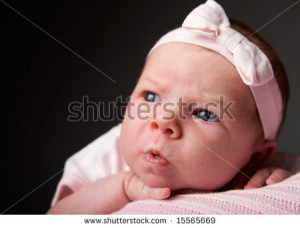 ... Emotions. Studio portrait of 14 days old baby girl making funny face