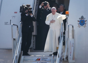 Pope Francis waves from the steps of his aircraft as he leaves ...