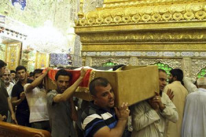 Mourners carry the coffin of a victim killed during an attack on a ...