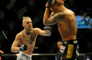 Sep 27, 2014; Las Vegas, NV, USA; Conor McGregor (blue gloves) fights ...