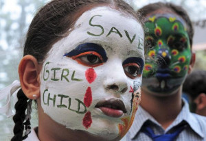young girl carries a message against female foeticide during a face ...