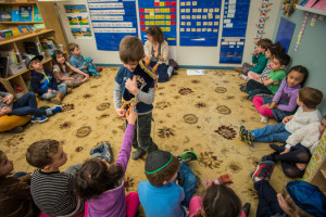 Ben Pollack holds a Torah during a morning meeting at Luria Academy, a ...