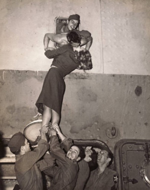 New York, 1945 - Actress Marlene Dietrich is hoisted up to kiss a GI ...