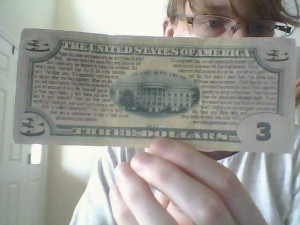 fake $3 bill with einstein and Bible verse on back
