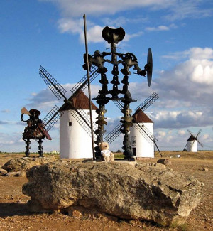 metal statue of Don Quixote with windmills in the background, La ...