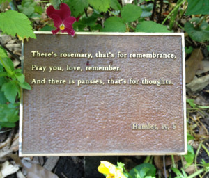 ... style garden where flowery Shakespeare quotes sit in flower beds