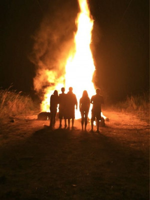 At the bonfire, out in the sticks, country backwoods, homegrown hicks.