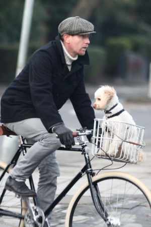 Ewan McGregor riding his bike with his dog.