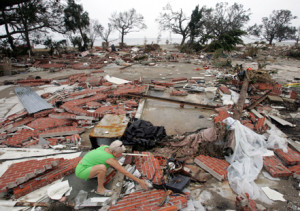 ... sorts through the debris of her home, destroyed by Hurricane Katrina