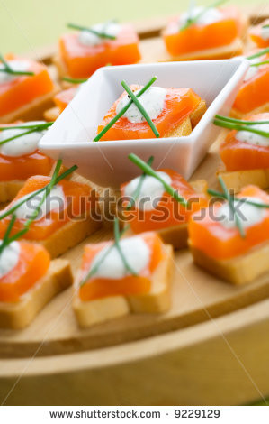 Delicious appetizers with smoked salmon and dill sauce - stock photo
