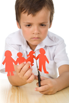 Sad boy cutting paper people family - divorce concept