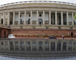 view of the Indian parliament building is reflected on a car in New ...