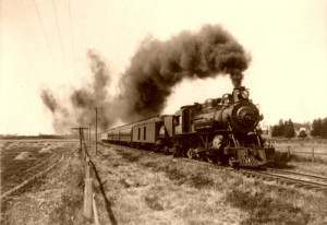 Railroad with steam engine in the foreground, 1915.