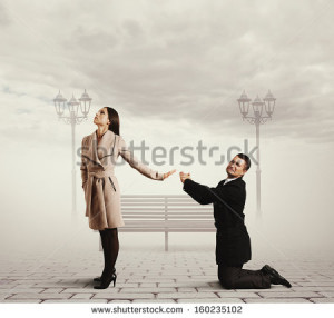 man standing on his knees and asking for forgiveness - stock photo