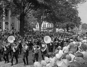High note: A marching band leads the festivities through a packed ...