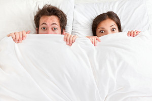 bigstock-Funny-couple-in-bed-looking-an-31765238