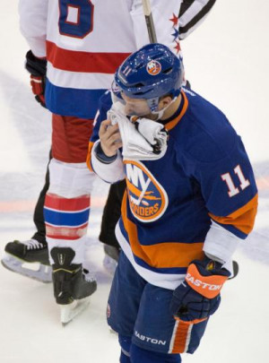 Lubomir Visnovsky of the Islanders leaves the game after a hit by Tom ...