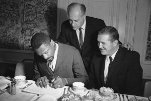 Bill Russell signs a three-year contract to play with the Boston ...
